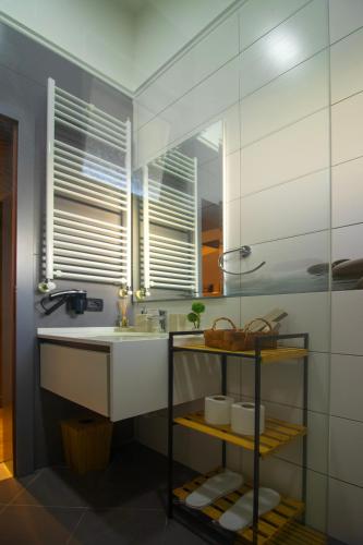 a bathroom with a sink and a mirror at ELITE LUXURY BOUTIQUE in Fier