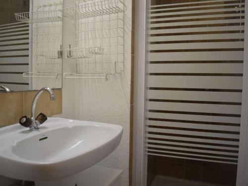 a bathroom with a sink and a glass shower at Appartement Saint-Raphaël, 2 pièces, 4 personnes - FR-1-226A-23 in Saint-Raphaël