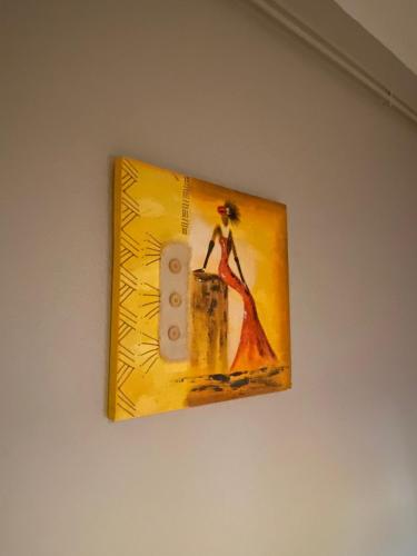 a picture of a woman in a dress hanging on a wall at CHEZ NOUS BIS in Commercy