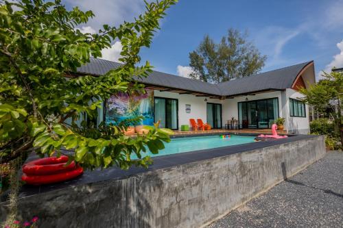 a house with a swimming pool in front of it at Villa loved beach AO Nam Mao krabi in Ao Nam Mao