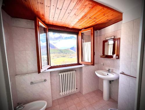 a bathroom with a sink and a window at Hotel Pinguino in Pescasseroli