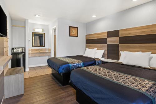 オークランドにあるベイ ブリーズ インのベッド2台とテレビが備わるホテルルームです。