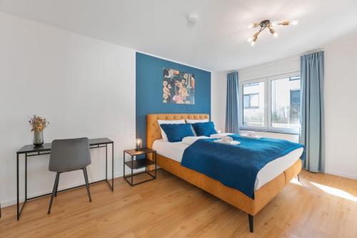 a bedroom with a bed and a desk and a chair at FiNEST Design Stuttgart Airport Messe in Ostfildern