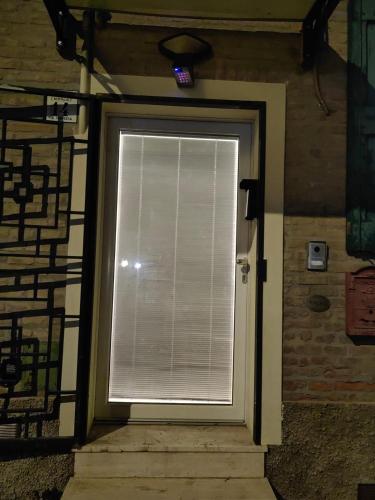 a door with a window with blinds on it at PIGRO House - Bologna Airport Suite in Bologna