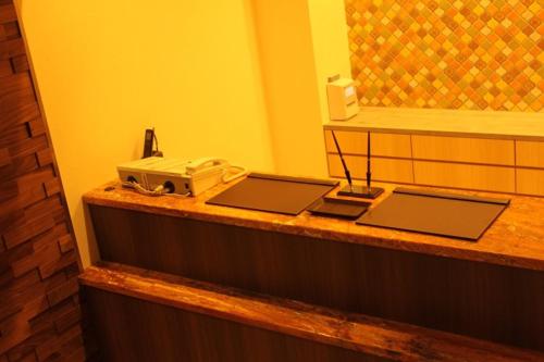 a counter with two laptops and a telephone on it at Hotel Richie Richie - Vacation STAY 25058v in Osaka
