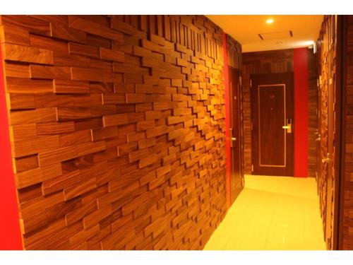 a hallway with a brick wall in a room at Hotel Richie Richie - Vacation STAY 25058v in Osaka