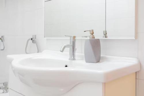 a white bathroom with two sinks and a mirror at Casa Paradiso sul Mare delle Aci in Aci Catena