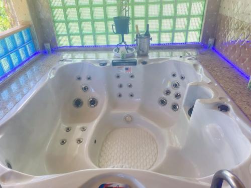 a large white bath tub in a room at Windbreak Villa in Buff Bay