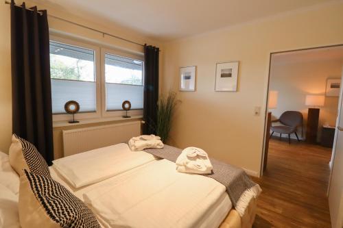 Katil atau katil-katil dalam bilik di Das Frühstückshotel Sankt Peter-Ording
