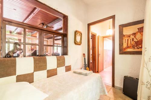 a bedroom with a bed and a large window at Villa OINOI with Pool for Luxury Vacation and Events in Marathón