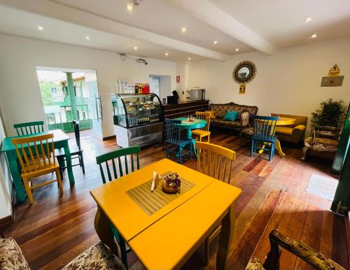 a living room with a yellow table and chairs at Usgar San Pedro Boutique in Cusco