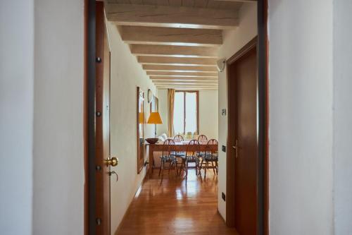 a hallway leading to a dining room with a table at Antiche Mura - Bassano Dieda in Bassano del Grappa