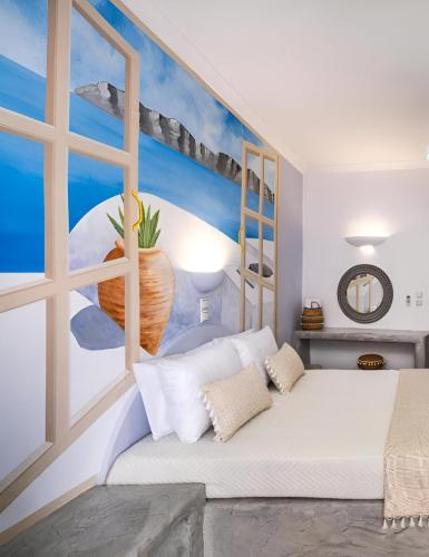 a bedroom with a large white bed and a window at Vinas Place City Center in Fira