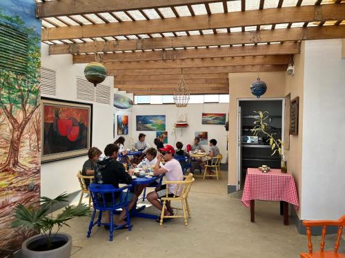 a group of people sitting at tables in a restaurant at Aloha Lobitos in Lobitos