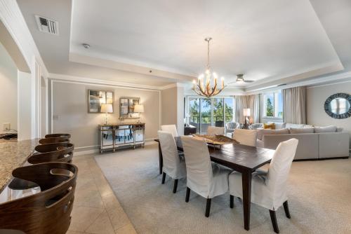 a dining room and living room with a table and chairs at Ocean View Residence 608 located at The Ritz-Carlton in Upper Land