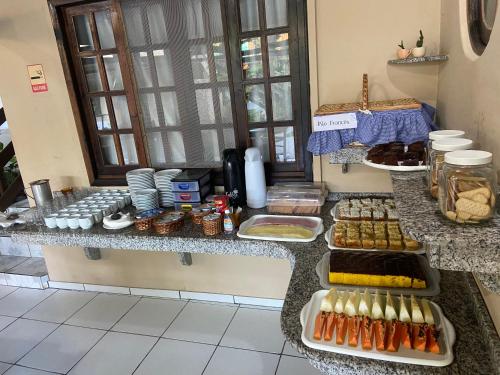 a kitchen with a counter with food on it at Pousada Paraíso in Ilha do Mel