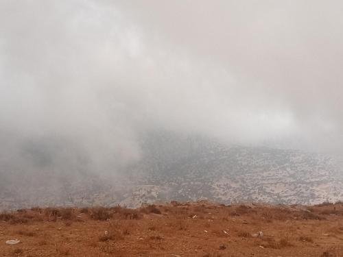 a foggy view of a city from the top of a hill at Dana Rose camp outdoor camping in Dana