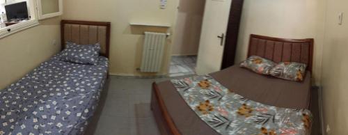 a bedroom with two beds and a table at dreamHome in Sétif