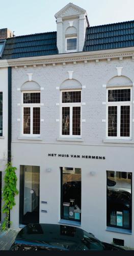 Ein weißes Gebäude mit einem Schild, auf dem steht, dass keine Home-Yard-Therapie stattfindet. in der Unterkunft Het huis van Hermens in Meerssen