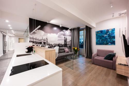 a kitchen and a living room with a couch and a table at Premium Apartments by Wawel Castle in Krakow