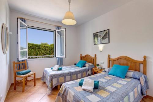 two beds in a room with a window at Villa Santo Grande by Villa Plus in Santo Tomás