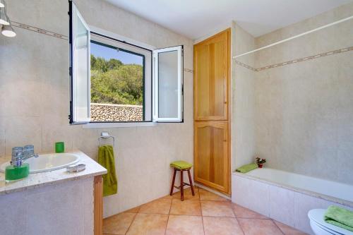 a bathroom with a sink and a tub and a window at Villa Santo Grande by Villa Plus in Santo Tomás