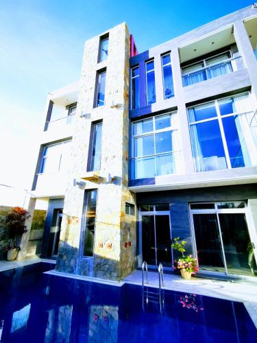 a building with a swimming pool in front of it at Hill Valley Asilah - Luxury Living & Boutique Hotel in Asilah