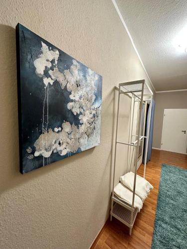 a painting hanging on a wall in a room at Victoria Apartment in Chemnitz