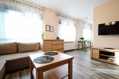 a living room with a couch and a table at Apartament Lukas in Kędzierzyn-Koźle