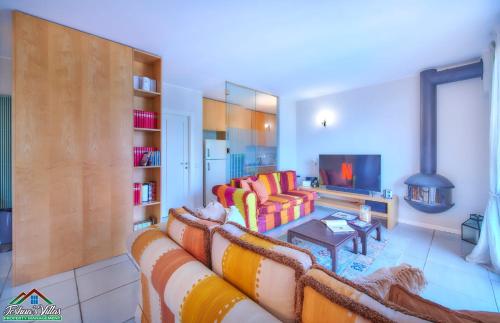 a living room with a couch and a tv at Casa Marina Bellagio private garden in Bellagio