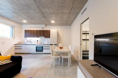 a living room and kitchen with a table and chairs at HouSmart Toscana 53 White in Bologna