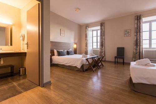 a hotel room with a bed and a desk in it at La Bastide de Sanilhac in Sanilhac