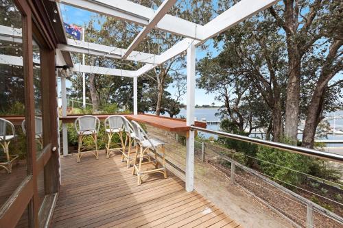 a wooden deck with a table and chairs on it at Bancroft Haven in Metung