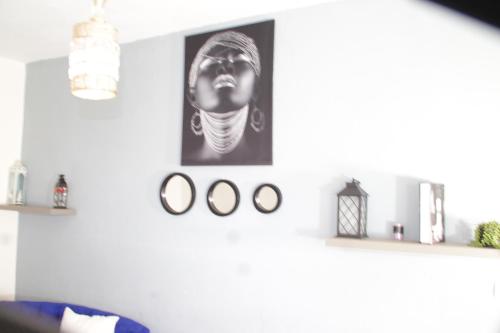 a living room with a black and white picture on the wall at KRISTAL HOME in Yaoundé