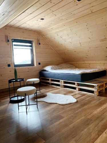 a bedroom with a bed in a wooden cabin at Duchałówka 2.0 in Koszarawa