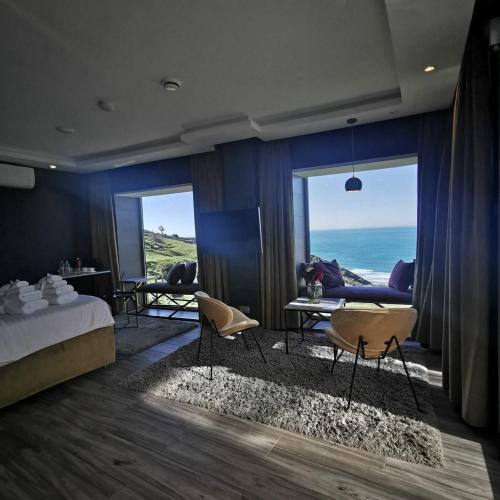 a bedroom with a bed and a view of the ocean at Hill Valley Asilah - Luxury Living & Boutique Hotel in Asilah