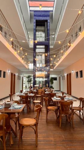 a dining room with wooden tables and chairs at Hotel Amaromar in Pontal do Paraná