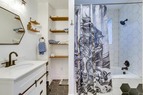 a bathroom with a shower curtain with a drawing on it at Cozy and Pet-Friendly Home - 3 Mi to Downtown Denver in Denver