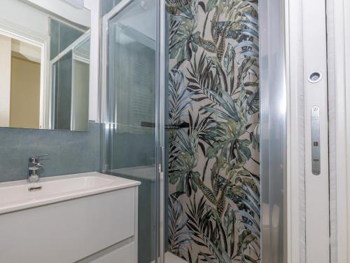 a bathroom with a shower with a sink and a mirror at Appartement Menton, 2 pièces, 4 personnes - FR-1-196-340 in Menton