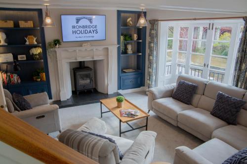 a living room with couches and a fireplace at Number Six in Ironbridge