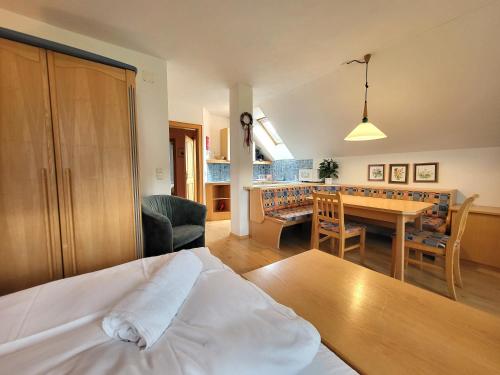 a bedroom with a bed and a dining room at Appartements Höller in Sankt Lorenzen ob Murau