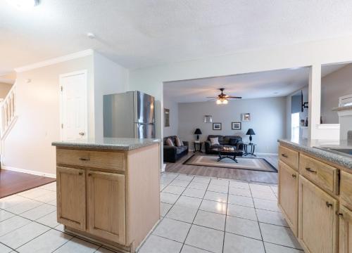 a kitchen with a counter top and a living room at Charming Suburb 20 Min to ATL! in Decatur