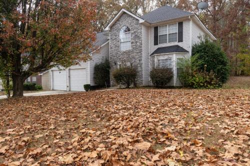 a house with a pile of leaves on the yard at Charming Suburb 20 Min to ATL! in Decatur