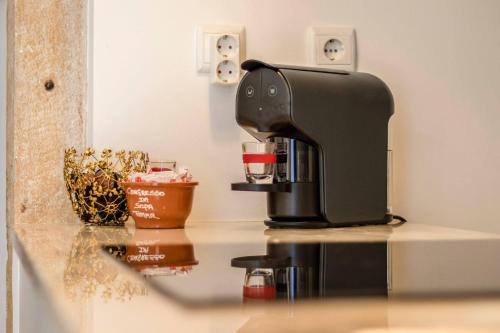 a black coffee maker sitting on a counter at Albergue do Infante in Tomar