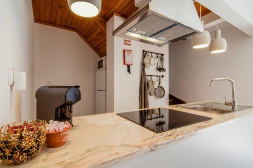 a kitchen with a counter top with a sink at Albergue do Infante in Tomar