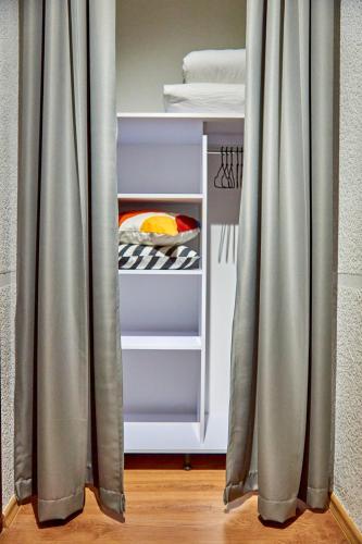 an open refrigerator with curtains in a room at Best Apartments on Kyryla & Mefodia in Mukacheve