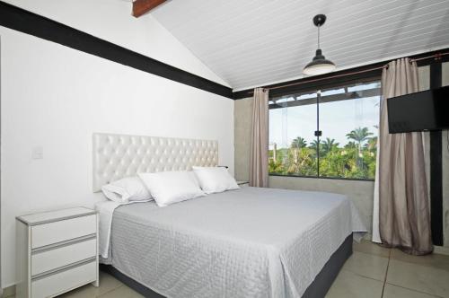 En eller flere senge i et værelse på Apartamento Portal da Ferradura