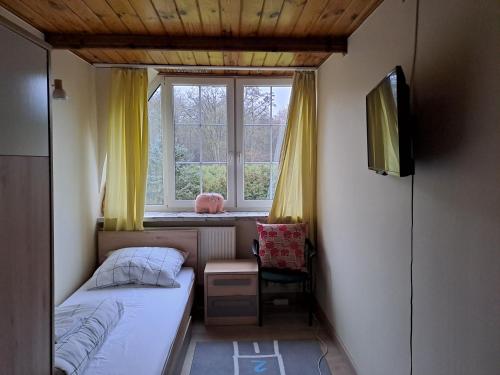 Villa Kasztanowa tesisinde bir odada yatak veya yataklar