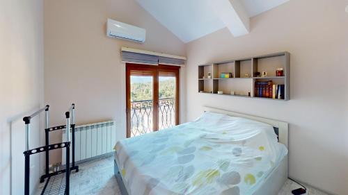 a small bedroom with a bed and a window at Sunny Villa in Kavac in Tivat