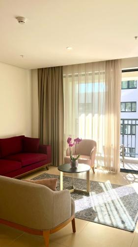 a living room with a red couch and a table at Sunraf Luxe Apartments in Budva